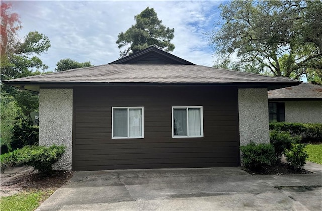 126 Lake View Cir, Brunswick, GA 31525 - view of property exterior featuring roof with shingles and stucco siding