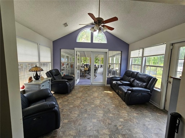 300 Crestview Dr, Woodbine, GA 31569 - living area featuring french doors, ceiling fan, a textured ceiling, stone finish floors, and vaulted ceiling