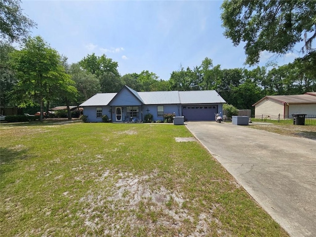 300 Crestview Dr, Woodbine, GA 31569 - ranch-style home featuring a garage, driveway, and metal roof