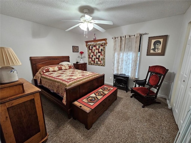 300 Crestview Dr, Woodbine, GA 31569 - bedroom with carpet flooring, a wood stove, a textured ceiling, baseboards, and a ceiling fan