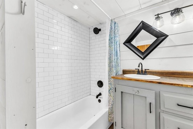 full bathroom featuring shower / bathtub combination with curtain and vanity