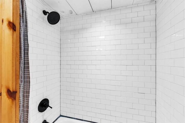 bathroom with bathing tub / shower combination