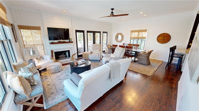 living area featuring recessed lighting, a large fireplace, dark wood finished floors, and ceiling fan