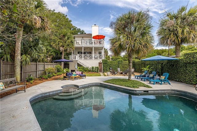 view of pool with a fenced in pool, a fenced backyard, a patio, and stairway