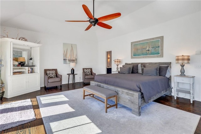 bedroom featuring lofted ceiling, dark wood finished floors, and a ceiling fan