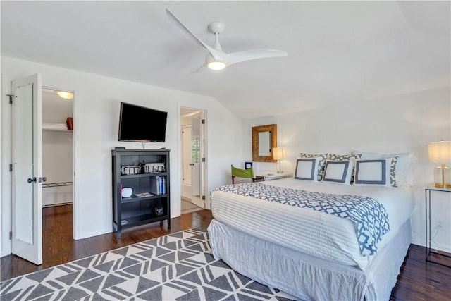 bedroom with a closet, a ceiling fan, vaulted ceiling, and dark wood-style flooring