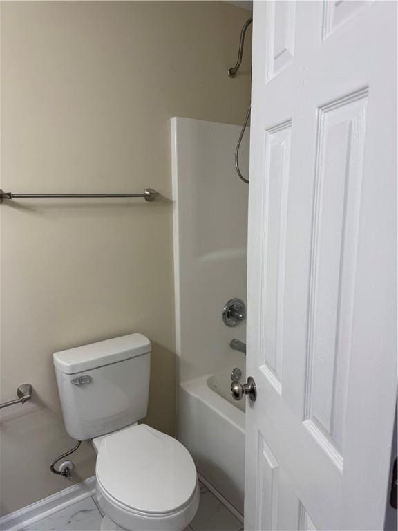 bathroom with shower / washtub combination and toilet