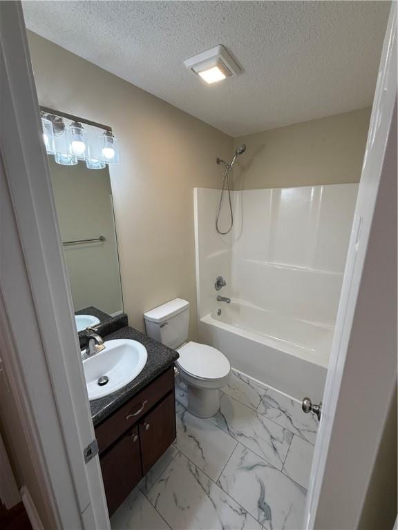 full bathroom with vanity, a textured ceiling,  shower combination, and toilet