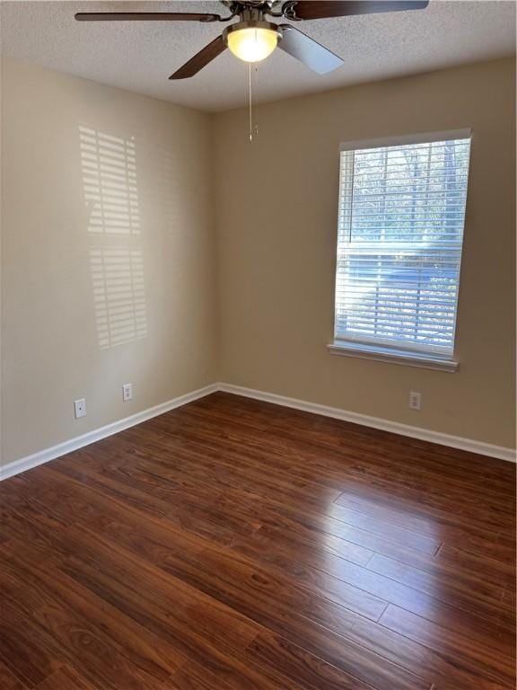 spare room featuring ceiling fan, dark hardwood / wood-style floors, and a textured ceiling