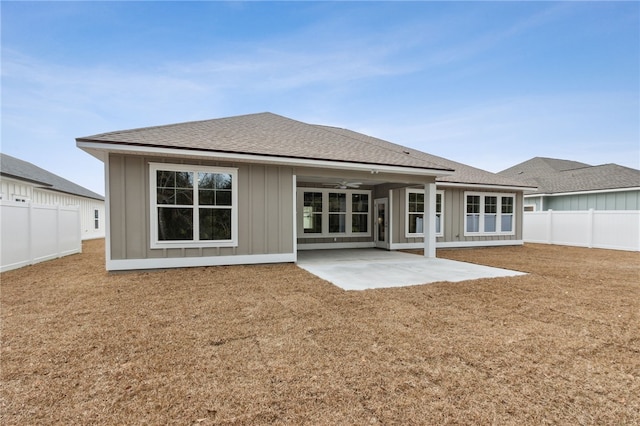 rear view of property featuring a patio, a yard, and ceiling fan