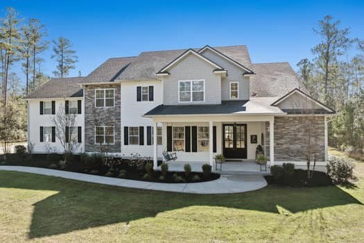 view of front of property with a porch and a front yard