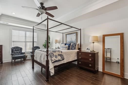 bedroom featuring baseboards and dark wood-style flooring