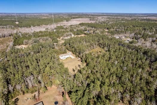 birds eye view of property featuring a wooded view