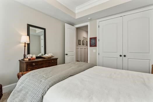 bedroom with a closet and ornamental molding