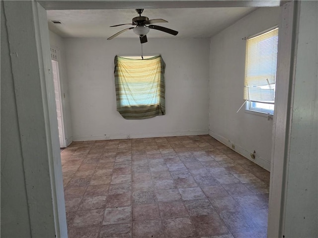 unfurnished room with ceiling fan