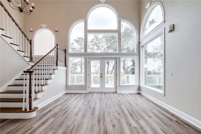 unfurnished living room featuring a towering ceiling and a healthy amount of sunlight