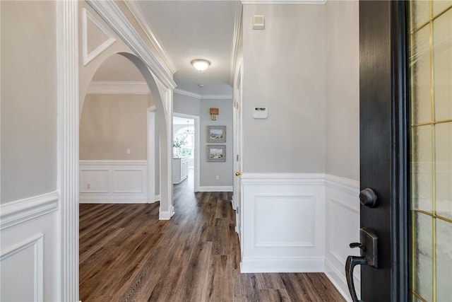 entrance foyer with dark wood-type flooring and crown molding