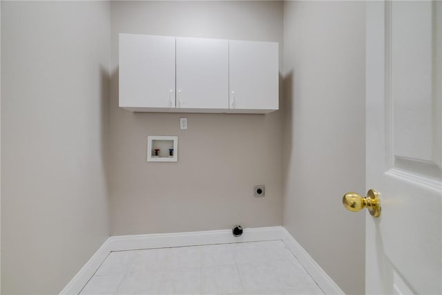 clothes washing area featuring washer hookup, electric dryer hookup, light tile patterned flooring, and cabinets