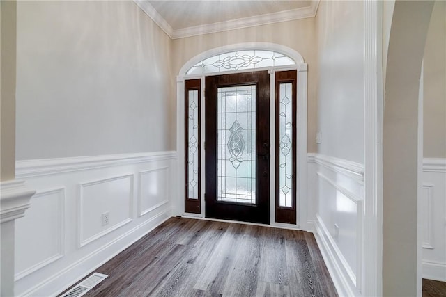 foyer entrance with crown molding and wood-type flooring