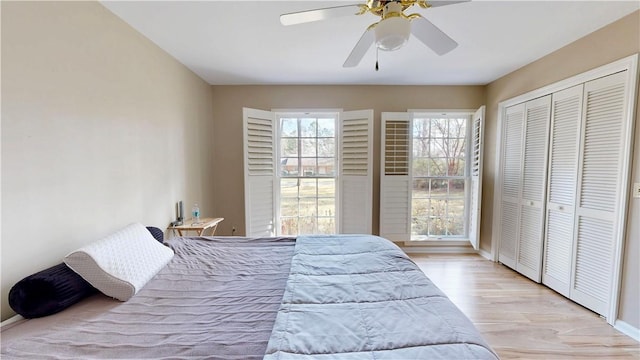 bedroom featuring ceiling fan, a closet, and light wood-type flooring