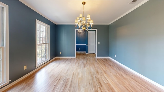 unfurnished room featuring crown molding, a chandelier, and light hardwood / wood-style floors