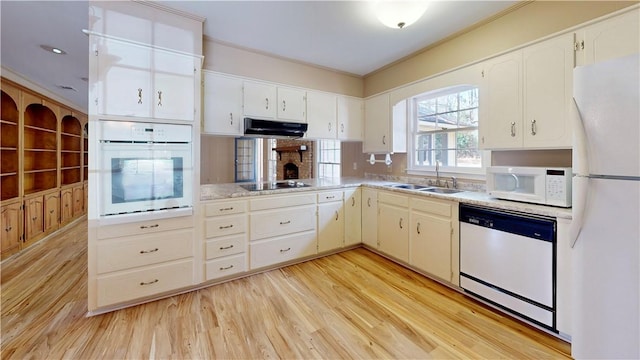 kitchen featuring sink, light wood-type flooring, white cabinets, ornamental molding, and white appliances