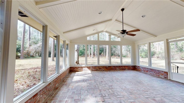 unfurnished sunroom featuring vaulted ceiling with beams and ceiling fan