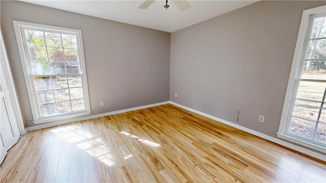 unfurnished room with ceiling fan and light wood-type flooring