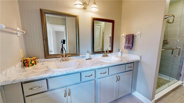 bathroom featuring vanity and a shower with door