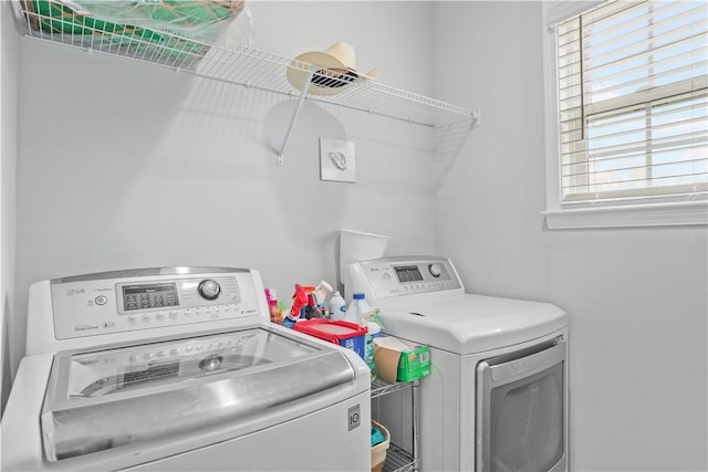 laundry area featuring plenty of natural light and washing machine and clothes dryer