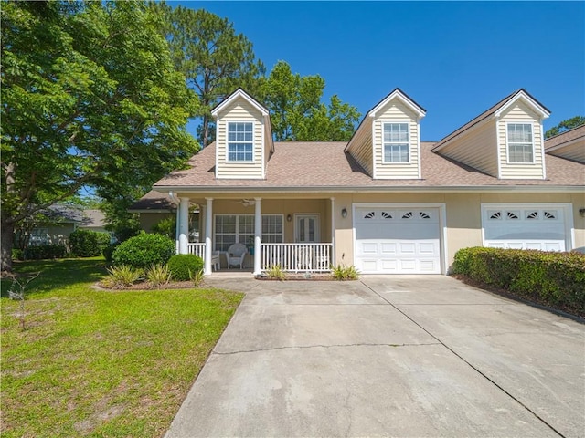 130 Peppertree Crossing Ave, Brunswick, GA 31525 - view of front of property featuring covered porch, an attached garage, a front lawn, roof with shingles, and concrete driveway