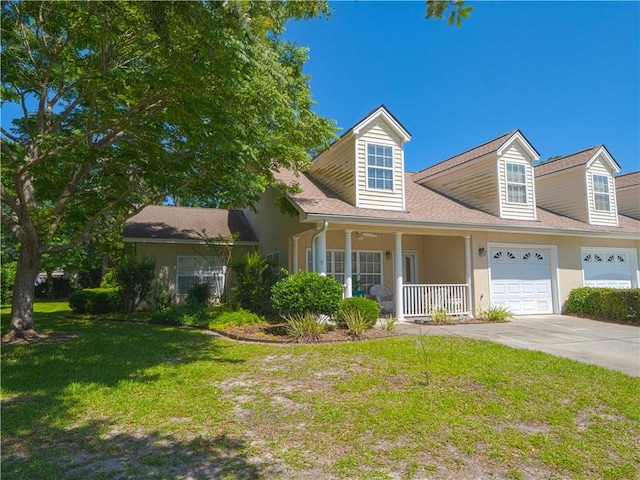 130 Peppertree Crossing Ave, Brunswick, GA 31525 - view of front of home featuring a front yard, covered porch, driveway, and stucco siding