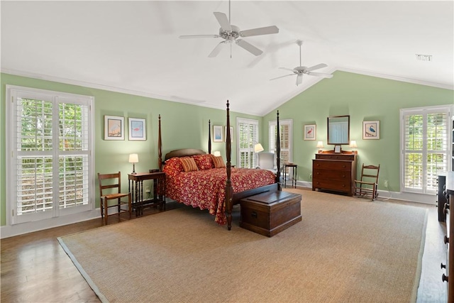 bedroom with baseboards, visible vents, multiple windows, and vaulted ceiling