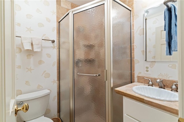 full bathroom featuring a shower stall, wallpapered walls, vanity, and toilet