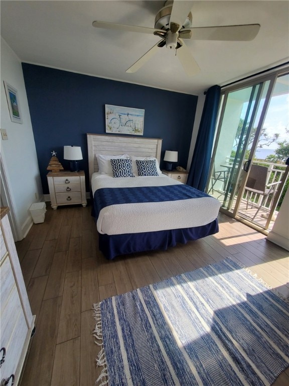 bedroom with dark hardwood / wood-style flooring, ceiling fan, access to exterior, and a wall of windows