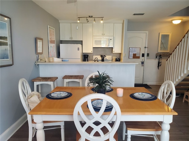 dining room with dark hardwood / wood-style floors