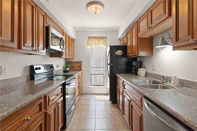 2502 Demere Rd Unit 3, Saint Simons Island, GA 31522 - kitchen featuring black appliances, brown cabinets, and light tile patterned floors