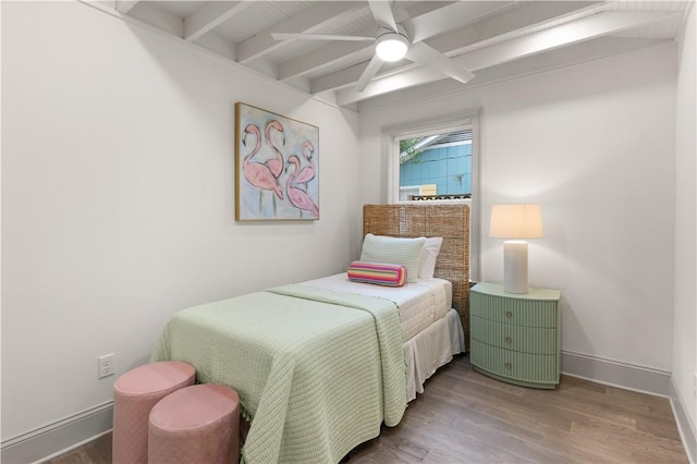 bedroom featuring beamed ceiling, hardwood / wood-style flooring, and ceiling fan