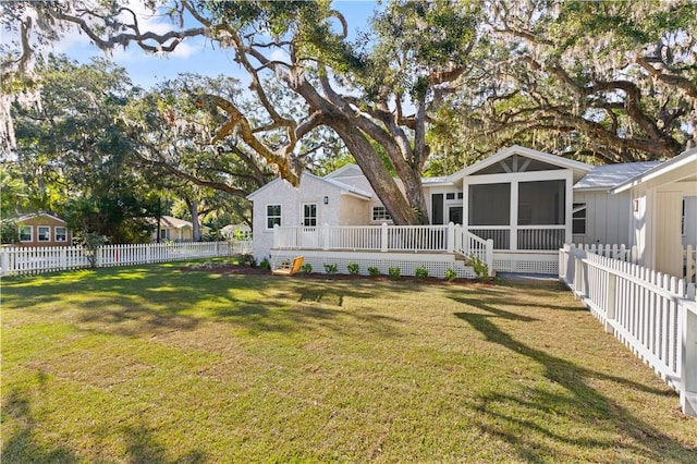 view of yard with a sunroom and a wooden deck