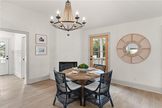 dining area featuring light hardwood / wood-style flooring and an inviting chandelier