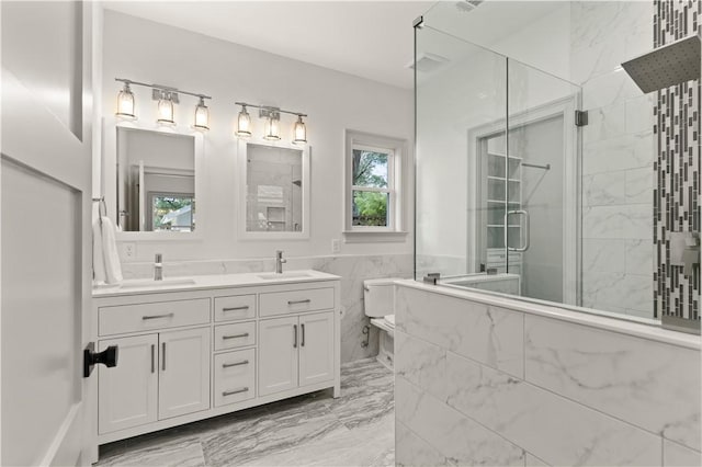 bathroom featuring vanity, tile walls, and a shower with shower door