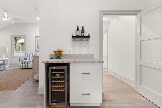 bar with light hardwood / wood-style flooring, wine cooler, ceiling fan, and lofted ceiling