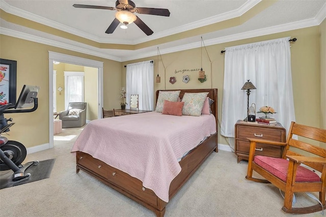 43 Coral Cv, Brunswick, GA 31523 - bedroom featuring light colored carpet, multiple windows, a tray ceiling, crown molding, and baseboards