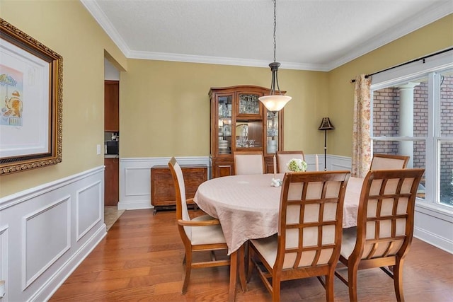 43 Coral Cv, Brunswick, GA 31523 - dining room with a wainscoted wall, ornamental molding, wood finished floors, and a decorative wall