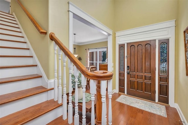 43 Coral Cv, Brunswick, GA 31523 - entrance foyer with wood finished floors, stairs, baseboards, and ornamental molding
