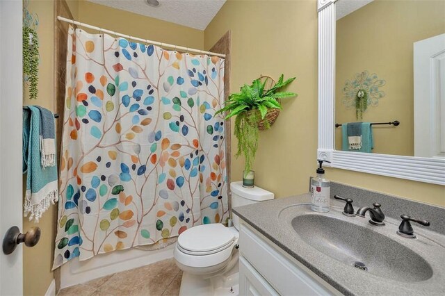 43 Coral Cv, Brunswick, GA 31523 - full bathroom featuring toilet, vanity, tile patterned flooring, shower / bath combination with curtain, and a textured ceiling
