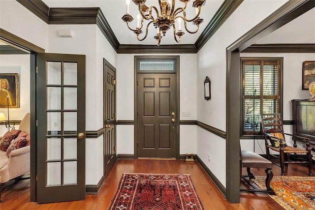 113 Cabretta Island Cir, Brunswick, GA 31520 - entrance foyer featuring baseboards, an inviting chandelier, wood finished floors, and crown molding
