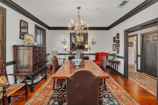 113 Cabretta Island Cir, Brunswick, GA 31520 - dining room with visible vents, a notable chandelier, wood finished floors, and crown molding
