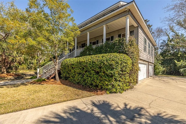 113 Cabretta Island Cir, Brunswick, GA 31520 - view of property exterior featuring a porch, driveway, stairs, and a garage