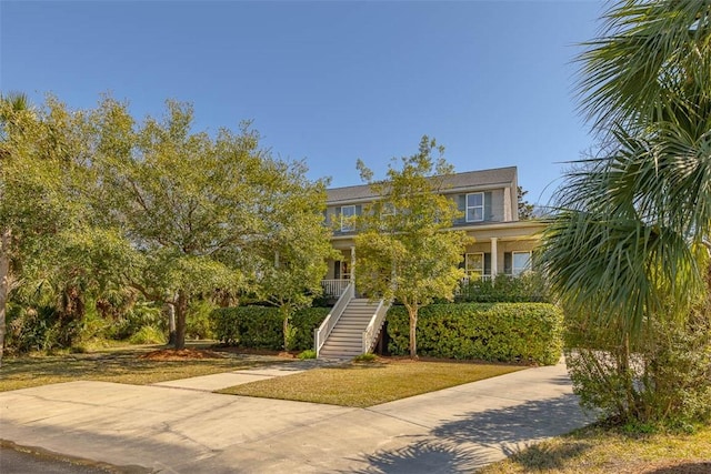 113 Cabretta Island Cir, Brunswick, GA 31520 - view of front of property with a porch, stairway, a front yard, and driveway